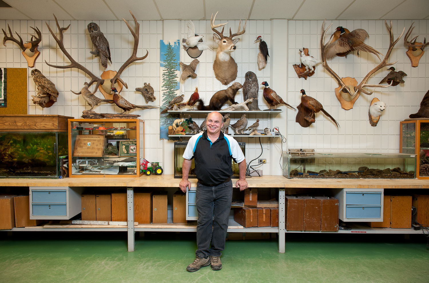 Man with animal head wall plaques by winnipeg editorial photographer