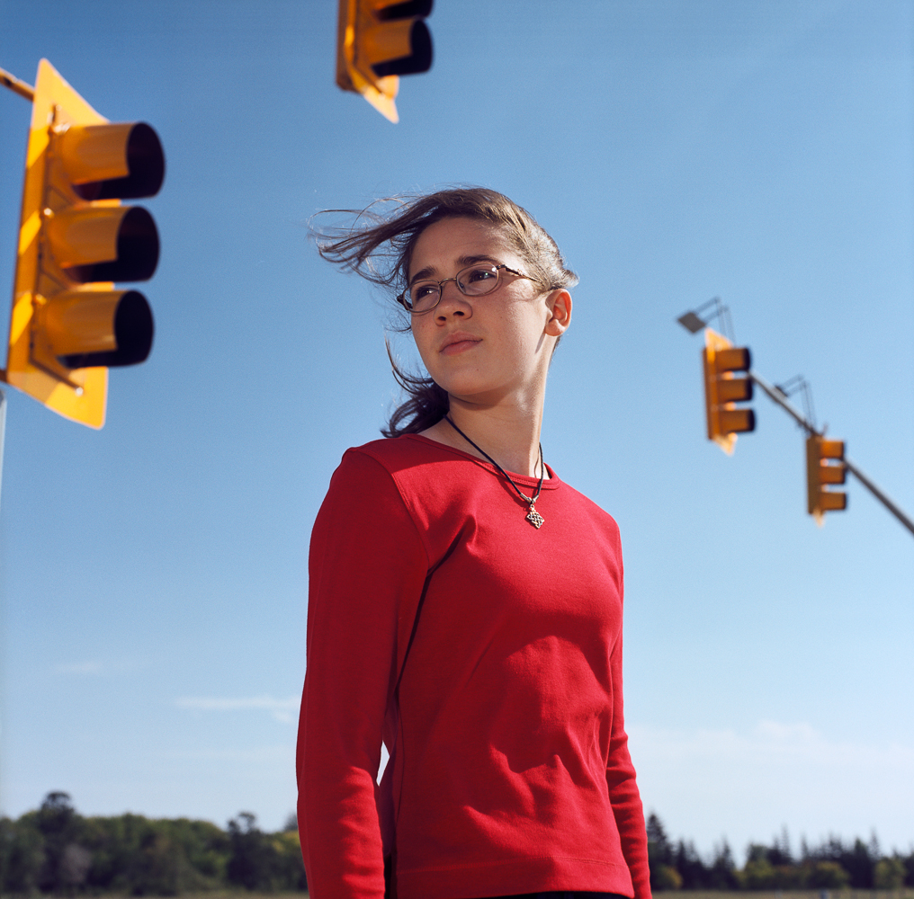 Girl under traffic lights by Winnipeg editorial photographer